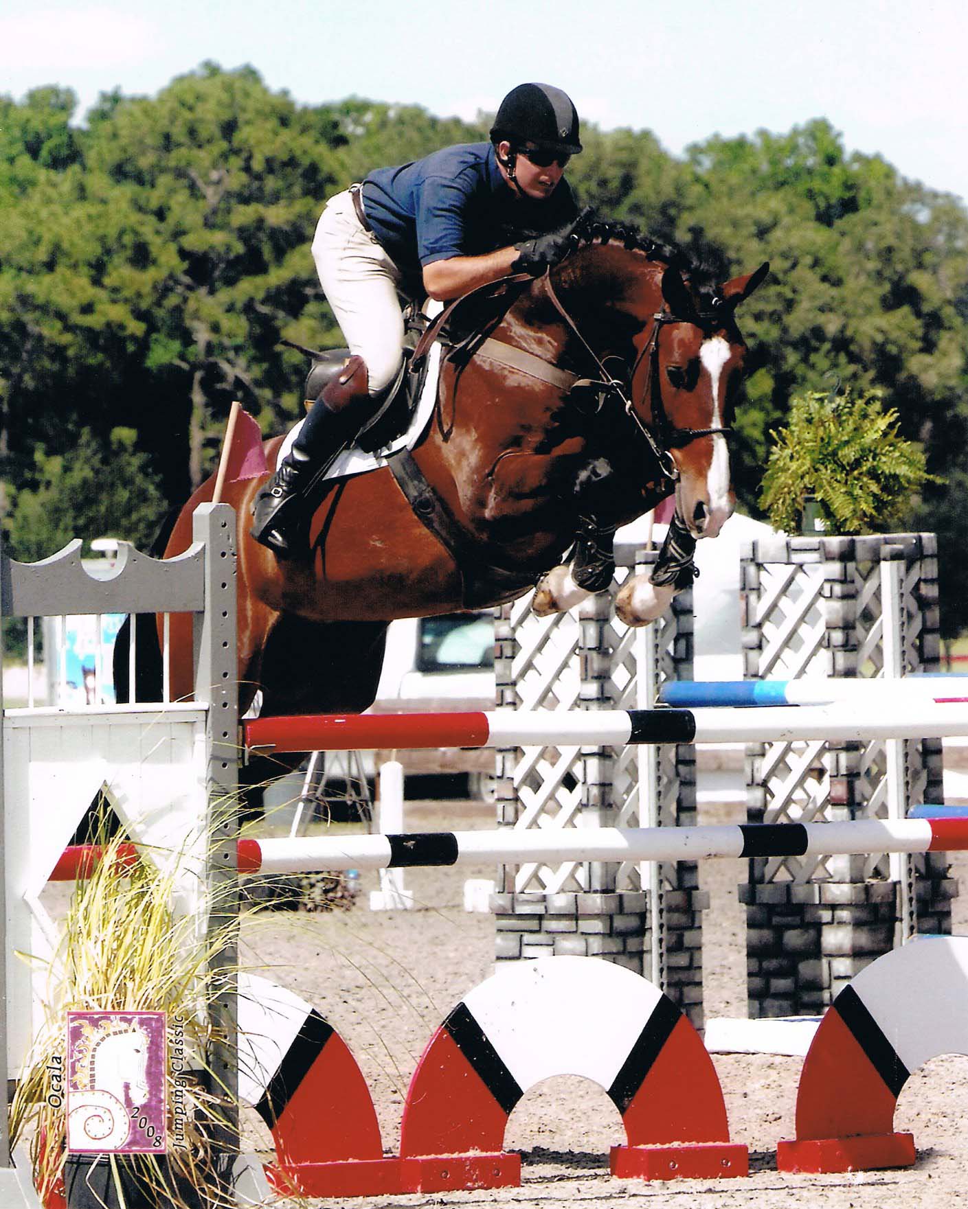 Man or horse jumping over fence